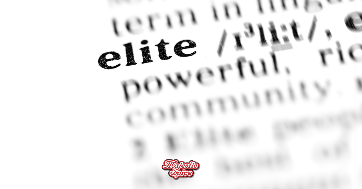 Close-up of the dictionary definition of the word 'elite,' with the pronunciation and part of the definition visible. In the bottom left corner, there's a Majestic Spice logo.