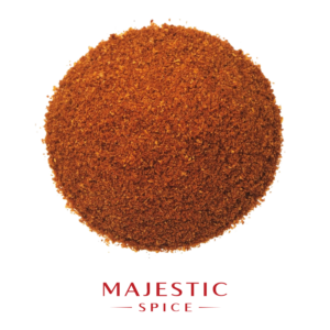 Round mound of finely ground reddish-brown ancho chili powder with a few scattered particles, with the red Majestic Spice logo below.