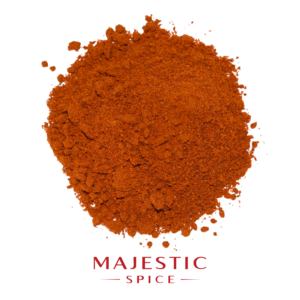 Mound of finely ground reddish-orange cayenne pepper powder with scattered particles, with the red Majestic Spice logo below.