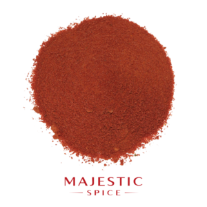 Mound of finely ground deep red salt-free chili powder with a smooth texture and scattered particles, with the red Majestic Spice logo below.