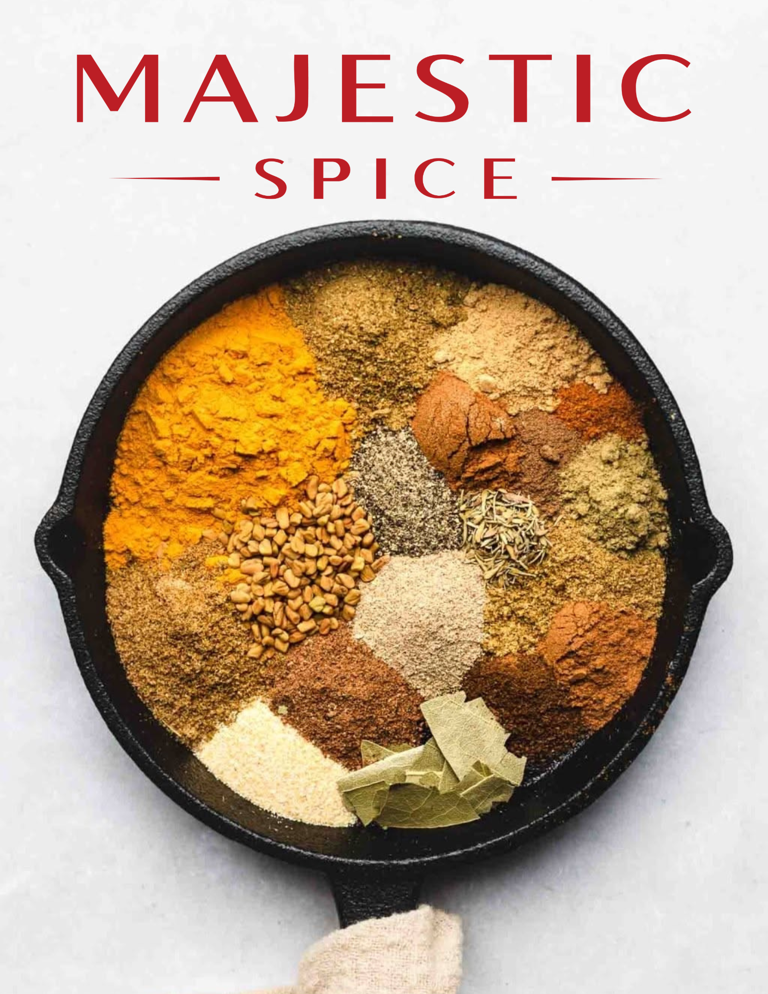 Majestic Spice logo above a black cast-iron skillet filled with neatly arranged ground spices, herbs, and whole seeds on a white background.